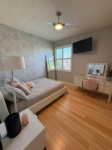 a bedroom with a bed and a chandelier