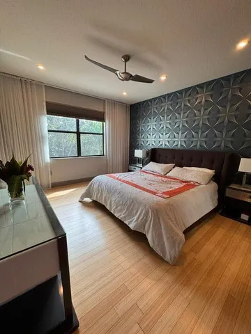 a bedroom with a large bed and a window