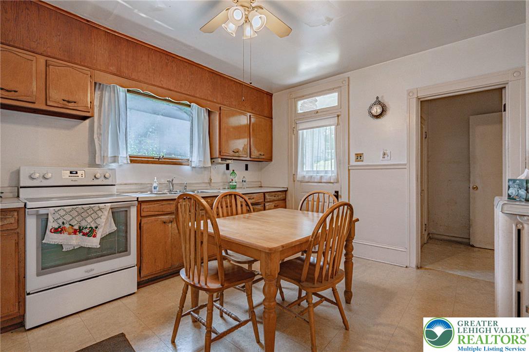 159 West Ridge Street Nesquehoning, PA 18240 - Photo 15 of 55 A well-lit kitchen with classic wooden cabinetry and a comfortable dining area.