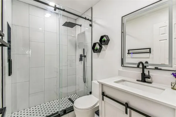 a view of a small space with wooden floor and a bathroom