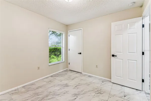 a bedroom with a bed and a ceiling fan