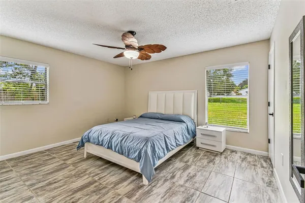 a view of a bedroom with wooden floor and a window