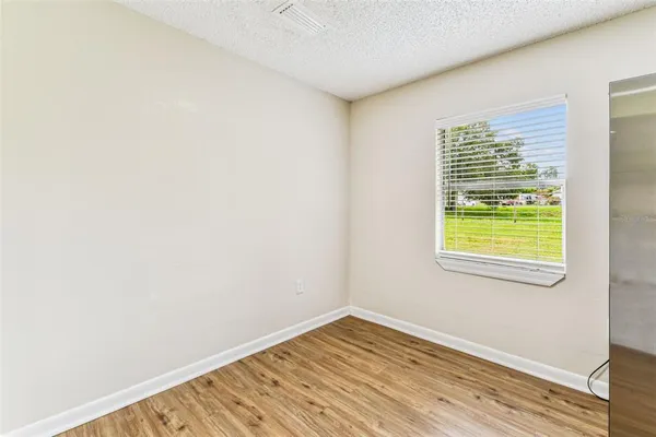 a view of a field with a tree in the background