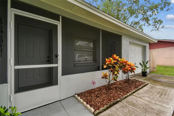 a view of a house with backyard and sitting area