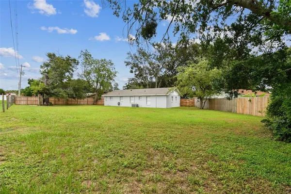a view of a swimming pool with an outdoor seating and a yard