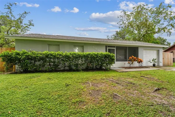 a kitchen with granite countertop a sink cabinets and wooden floor