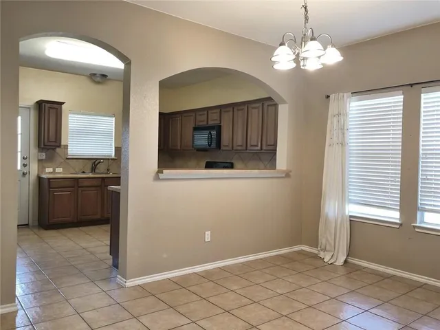 a view of a kitchen with a sink and dishwasher cabinets