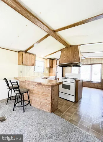 a kitchen with stainless steel appliances granite countertop a sink and a stove