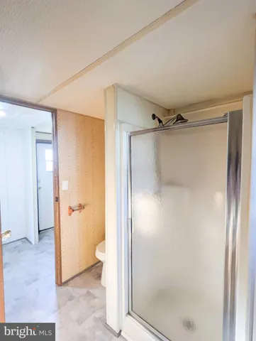 a bathroom with a glass shower door