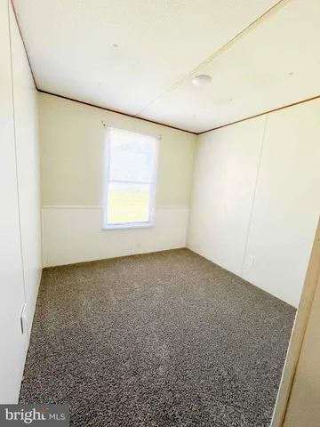 an empty room with a empty space and windows