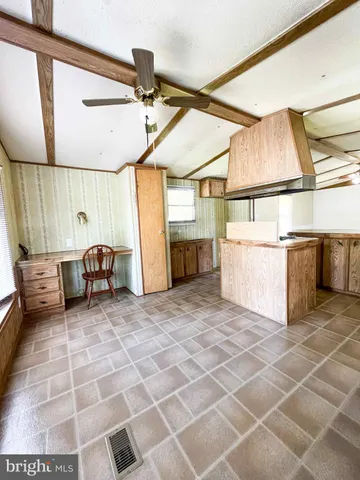 a view of a storage & utility room with furniture and a window