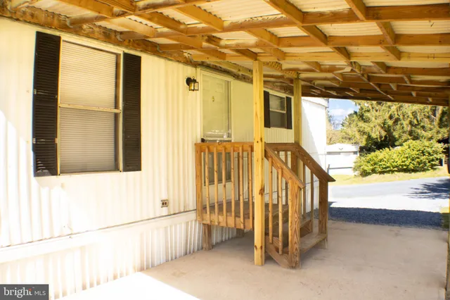 a view of a porch with a table and chairs
