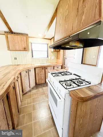 a kitchen with a stove a sink and a refrigerator