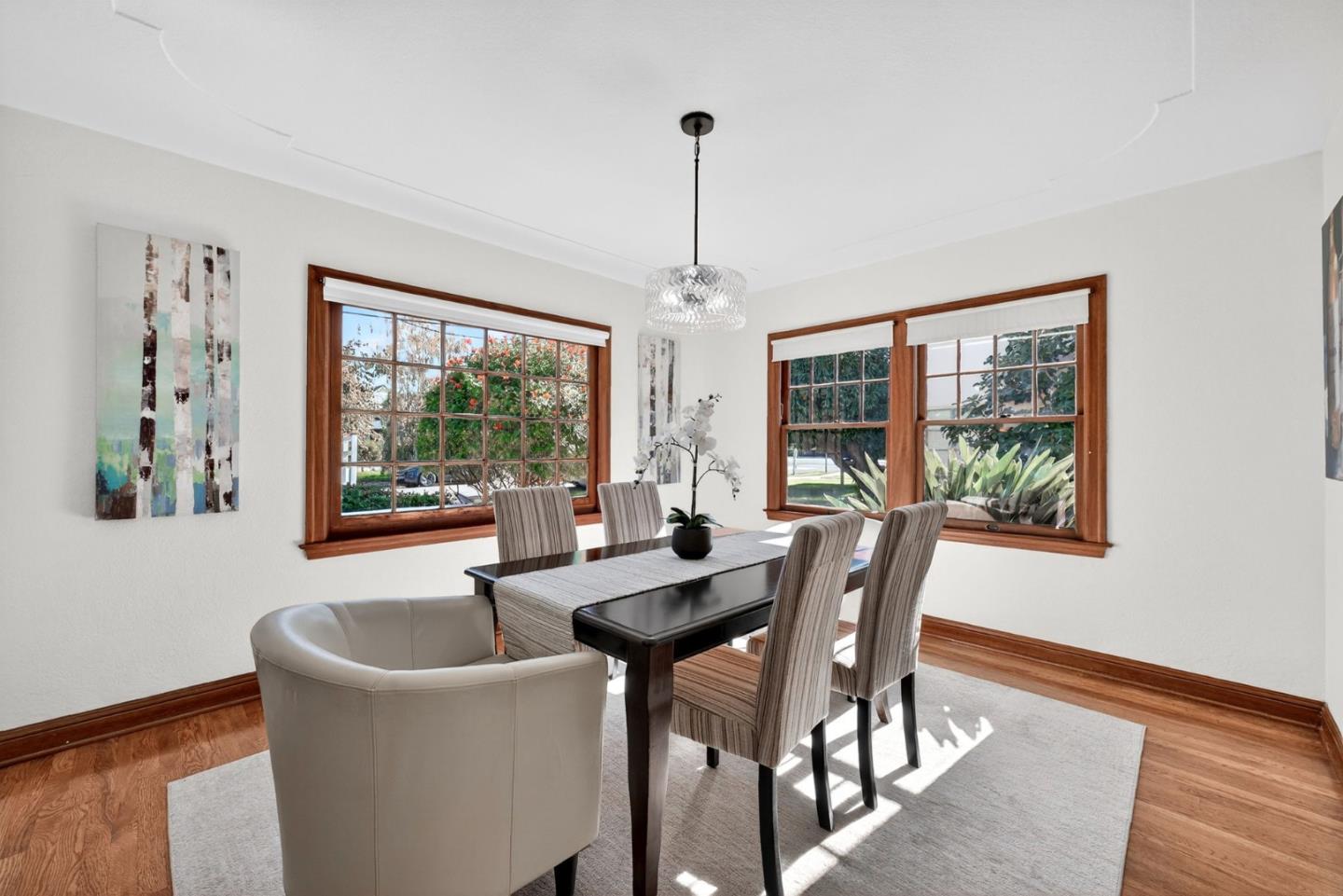 1087 Merle Avenue San Jose, CA 95125 - Photo 12 of 49 a dining room with furniture a chandelier and wooden floor