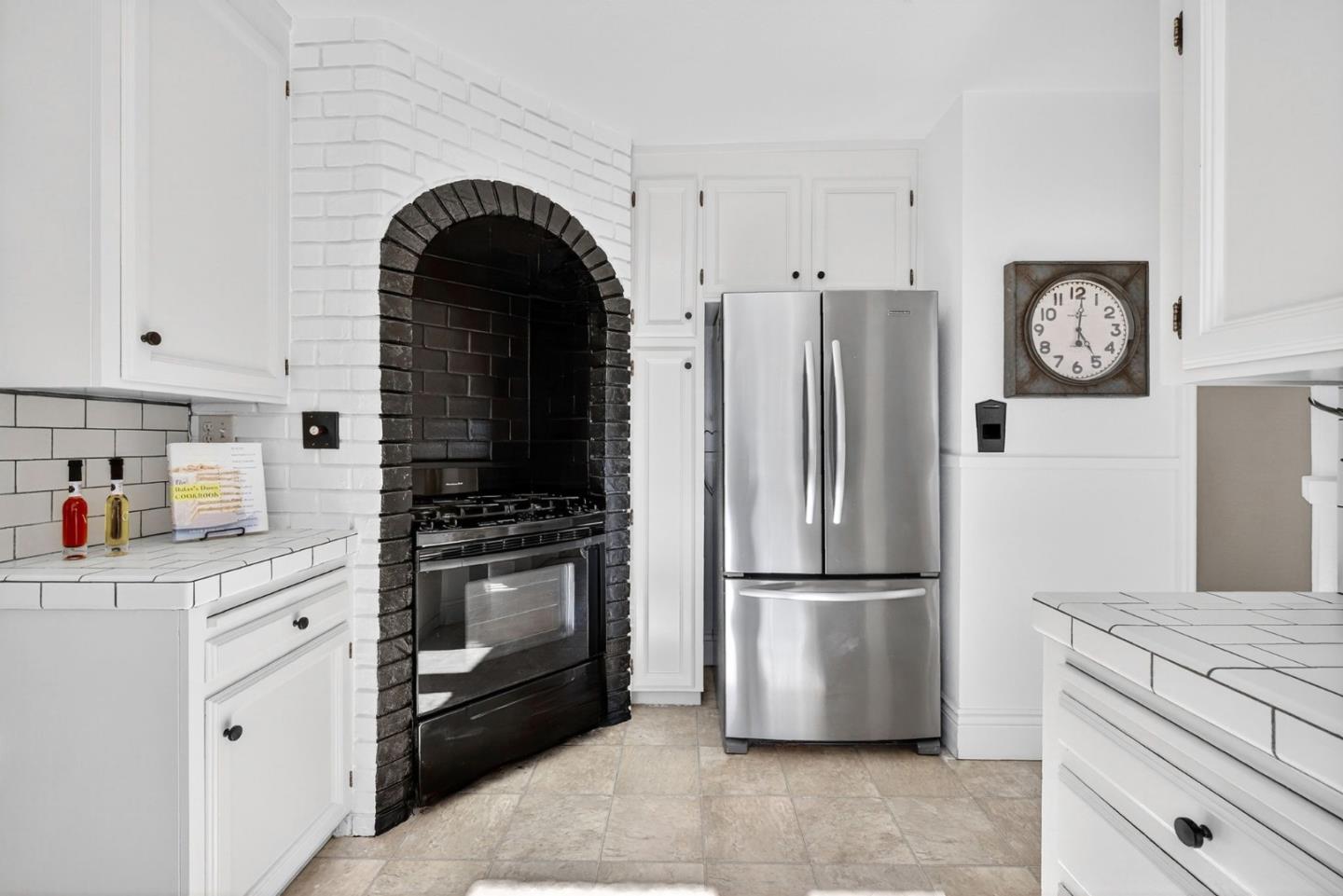 1087 Merle Avenue San Jose, CA 95125 - Photo 17 of 49 a kitchen with granite countertop a refrigerator and a stove top oven