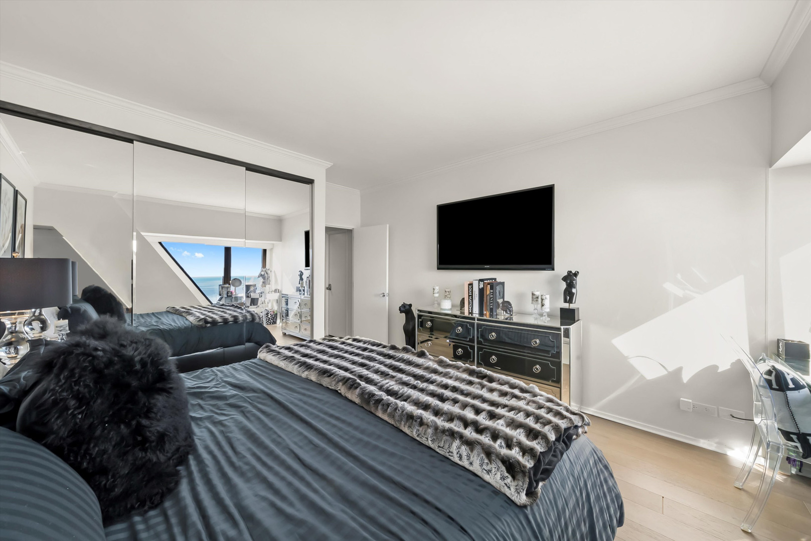 175 East Delaware Place, Unit 7107 Chicago, IL 60611 - Photo 19 of 42 a bedroom with furniture and a flat screen tv