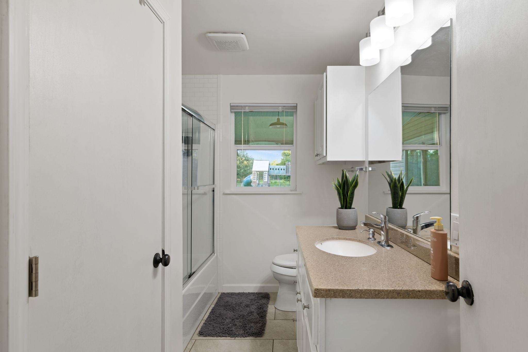 66 County Road 511 Corinth, MS 38834 - Photo 22 of 40 Bathroom vanity with a light speckled countertop, undermount sink, and chrome faucet