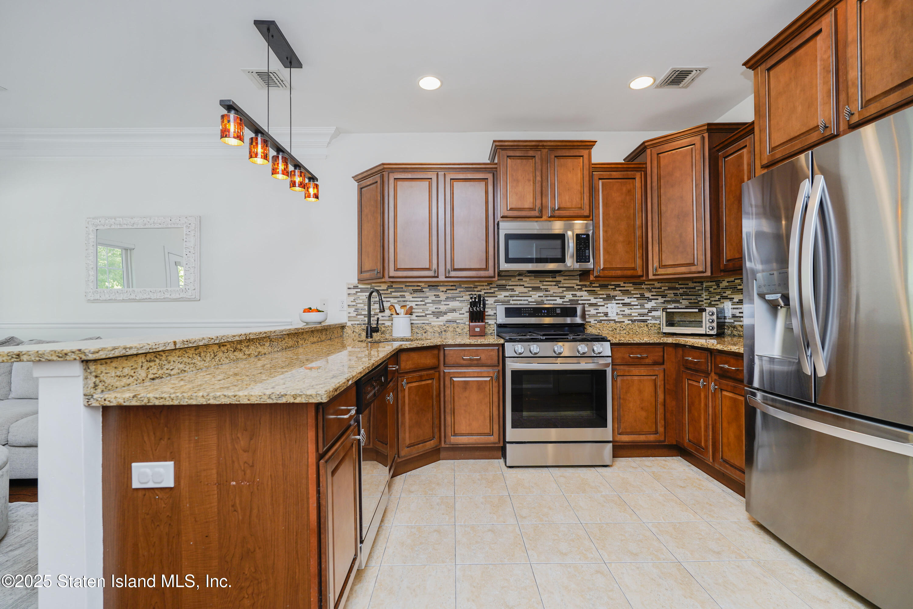 121 Presentation Circle Staten Island, NY 10312 - Photo 14 of 39 a kitchen with stainless steel appliances granite countertop a stove refrigerator sink and microwave