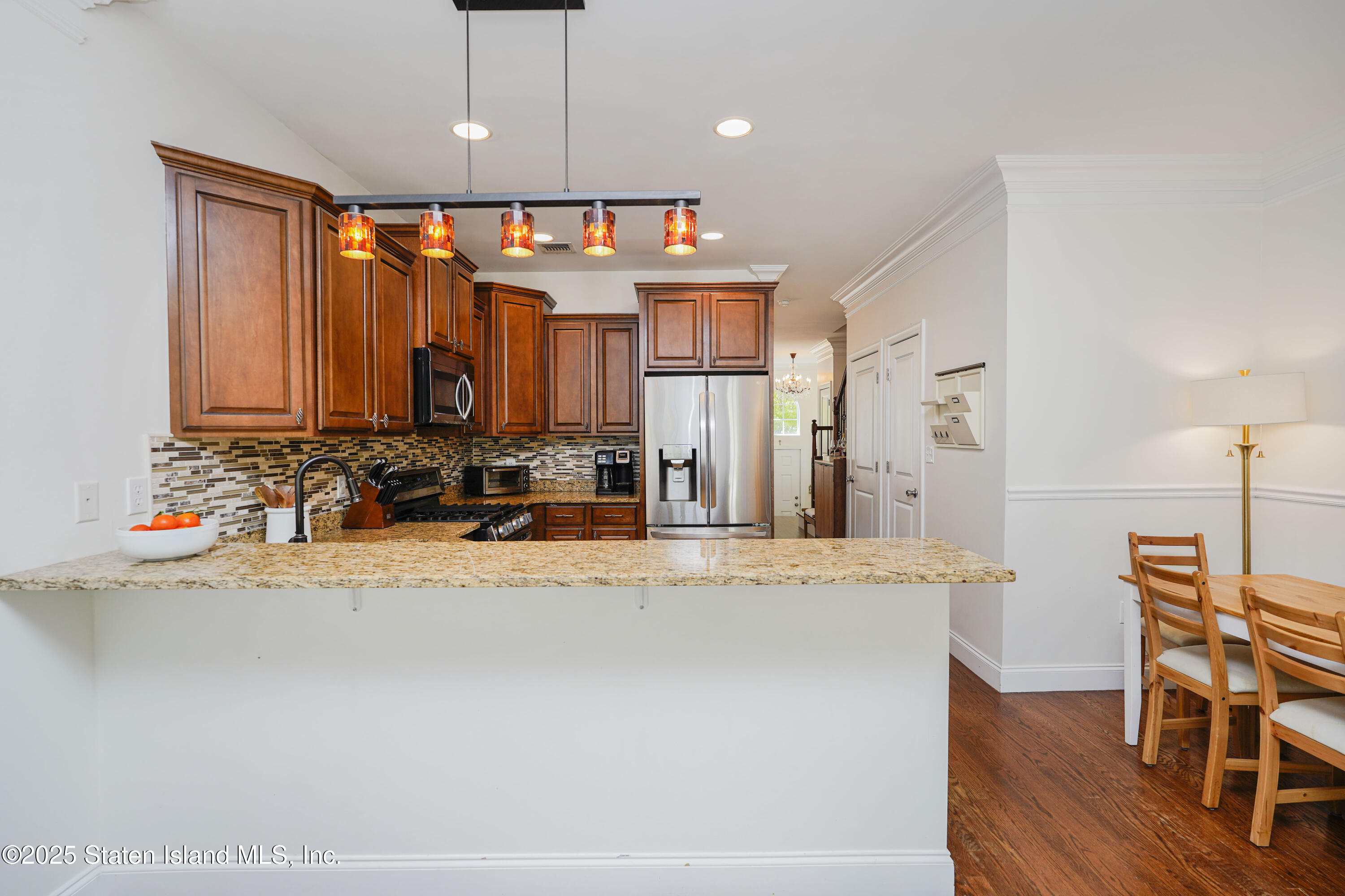 121 Presentation Circle Staten Island, NY 10312 - Photo 20 of 39 a view of a kitchen with kitchen island granite countertop a refrigerator and a stove top oven