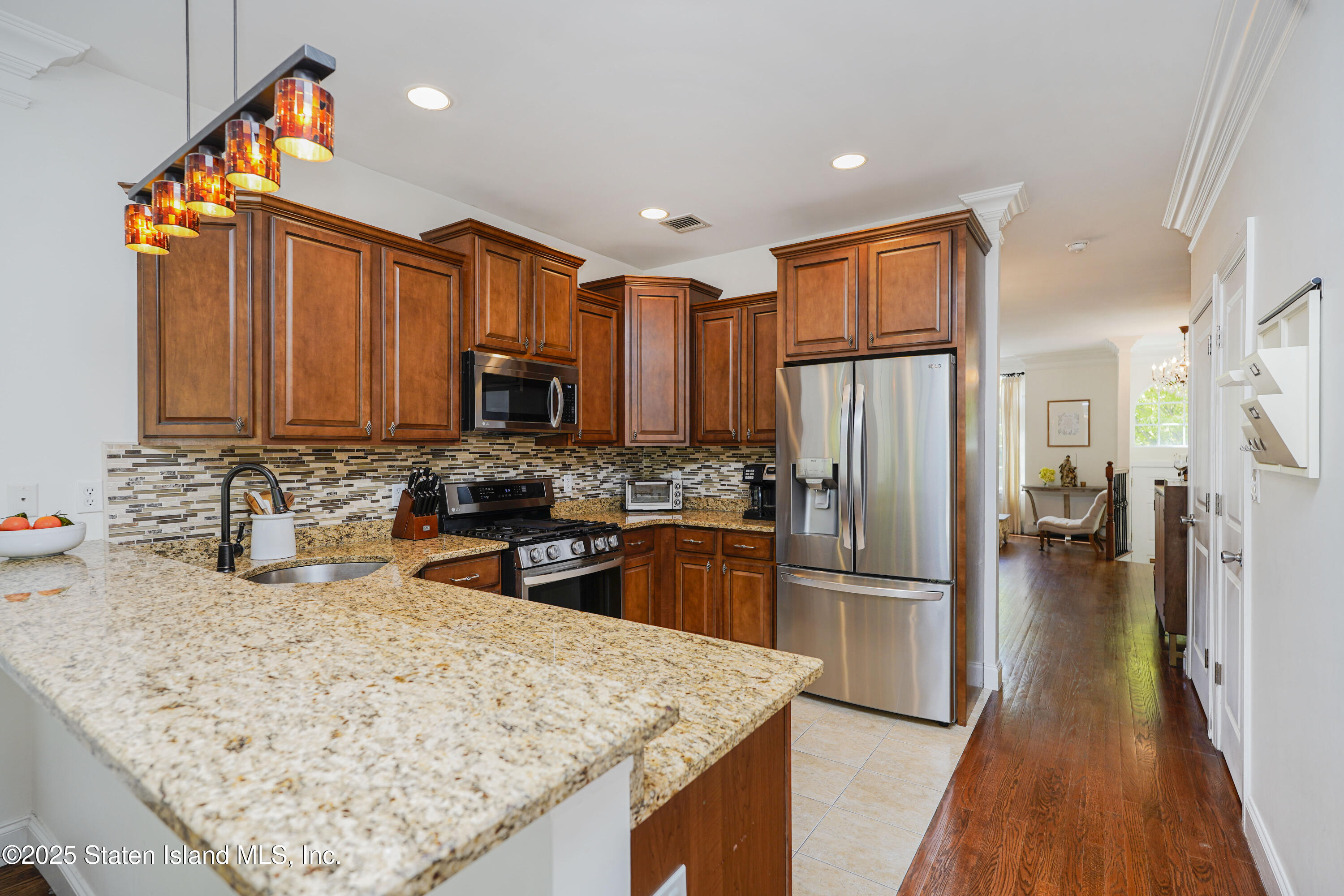 121 Presentation Circle Staten Island, NY 10312 - Photo 21 of 39 a kitchen with stainless steel appliances granite countertop a refrigerator a stove top oven a sink and dishwasher