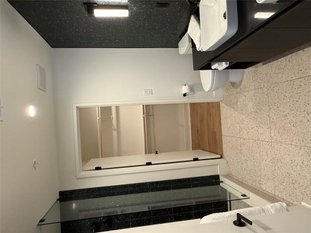 48 East Avenue, Unit 2509 Austin, TX 78701 - Photo 12 of 30 a bathroom with a sink and a mirror