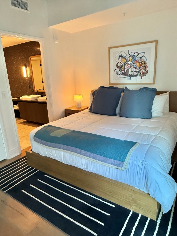 48 East Avenue, Unit 2509 Austin, TX 78701 - Photo 14 of 30 a bedroom with a bed and a flat screen tv