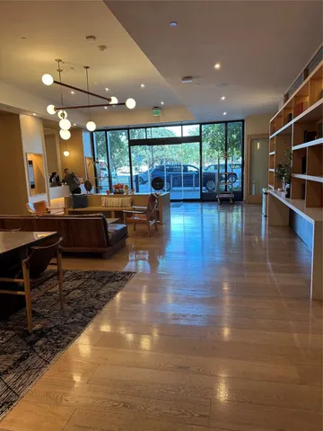 a view of a gym equipment with wooden floor