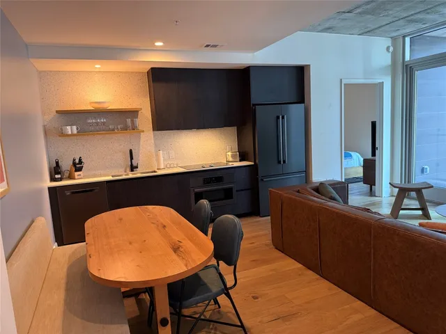 a kitchen with a table chairs sink and microwave