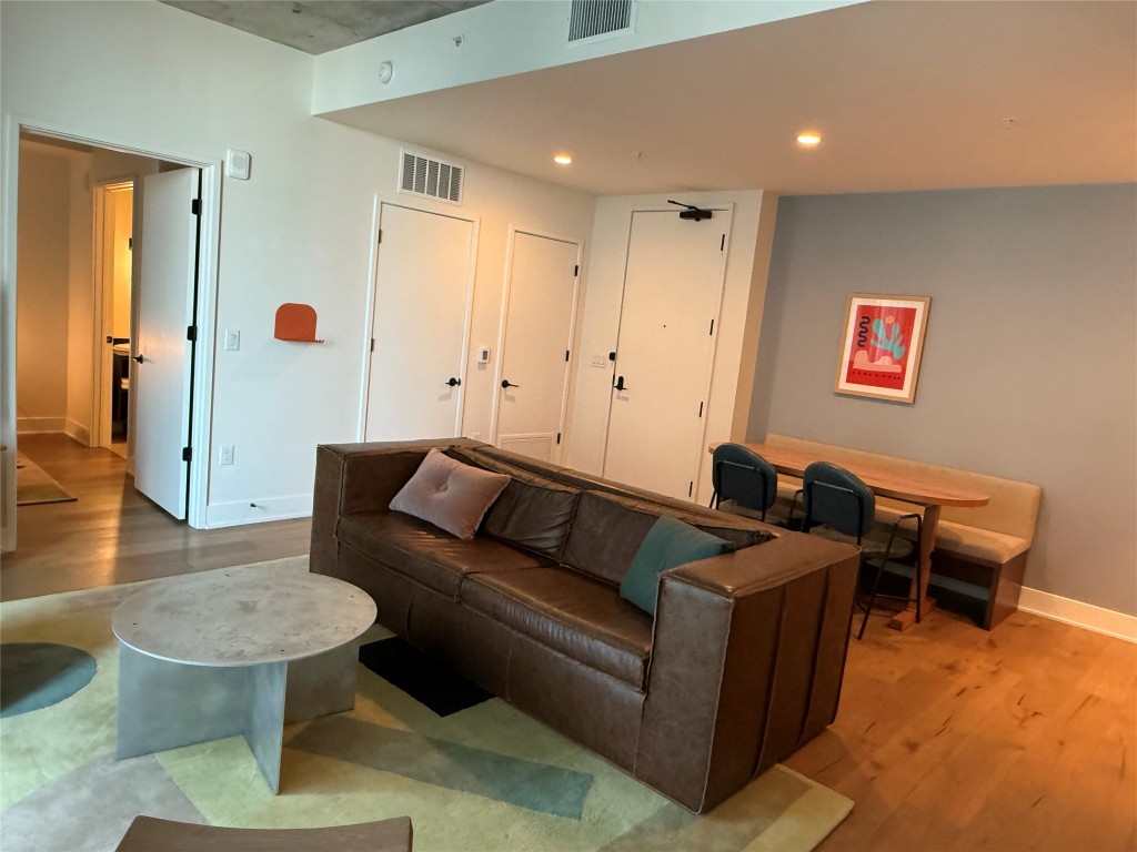 48 East Avenue, Unit 2509 Austin, TX 78701 - Photo 5 of 30 a living room with furniture and a wooden floor