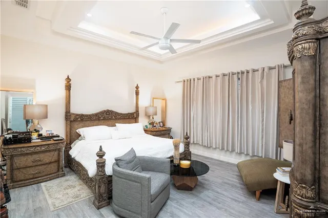 a bedroom with furniture and a large window