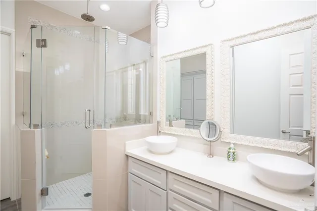 a bathroom with double vanity sinks and a mirror