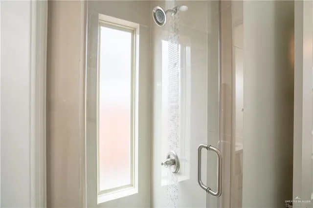 a bathroom with a glass shower door