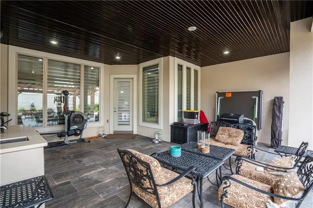 a work room with furniture and large windows