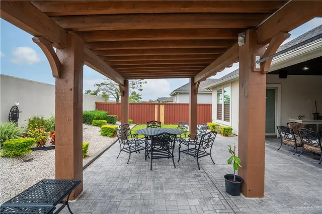 a view of a patio with table and chairs potted plants