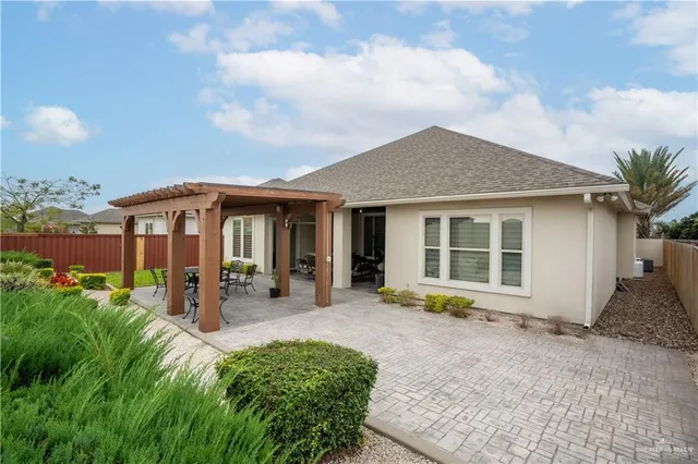 a view of a house with yard and sitting area