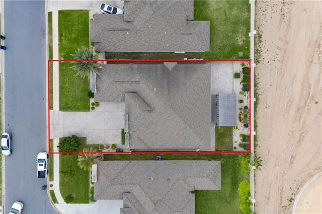 an aerial view of a house with a yard