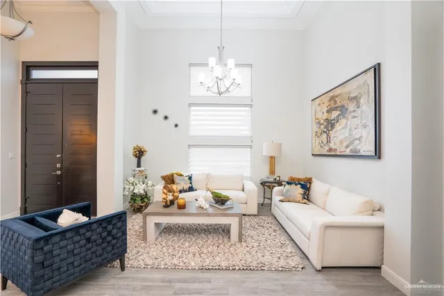 a living room with furniture and a chandelier