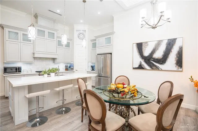 a kitchen with a dining table chairs and stove