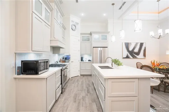 a kitchen with a sink stove and white cabinets