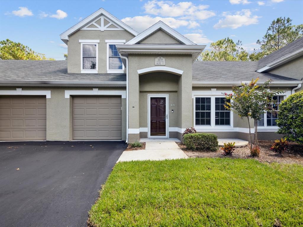 3619 Trafalgar Way, Unit 102 Palm Harbor, FL 34685 - Photo 1 of 53 a front view of a house with garden