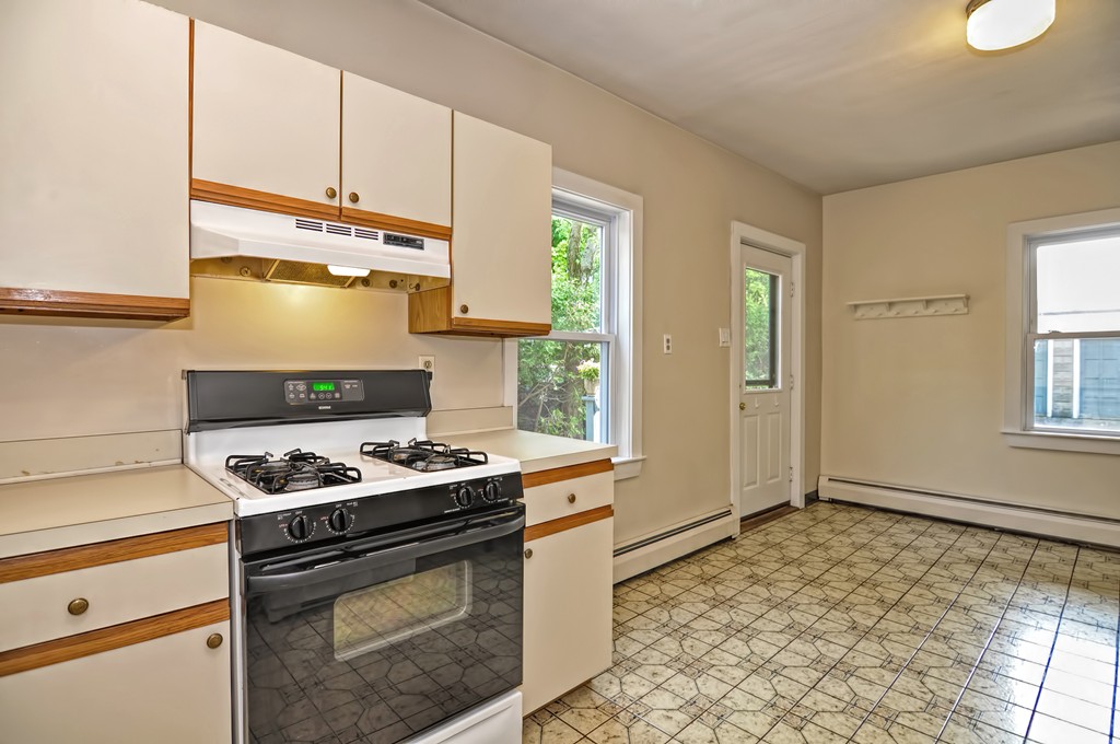 61 Reed Street, Unit 61 Cambridge, MA 02140 - Photo 7 of 22 a kitchen with stainless steel appliances granite countertop a stove and a refrigerator