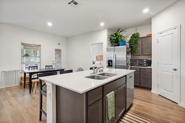 a kitchen with a sink stove and refrigerator
