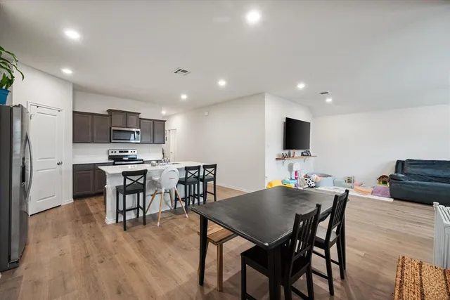 a view of kitchen with cabinets table and chairs