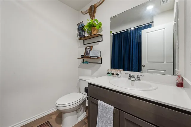 a bathroom with a sink a toilet and mirror