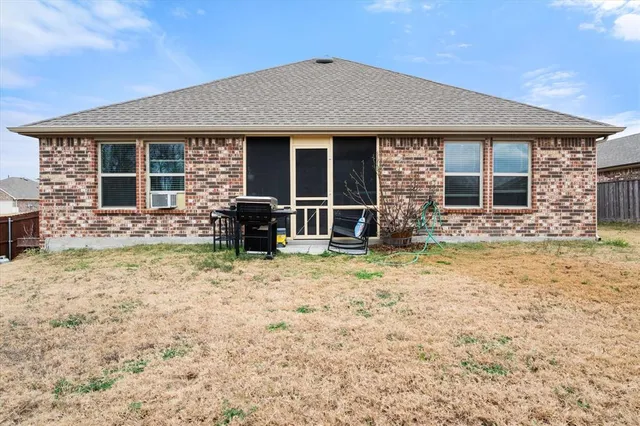a view of a house with a big yard and large trees