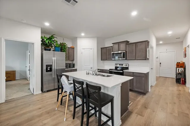 a kitchen with a table and chairs in it