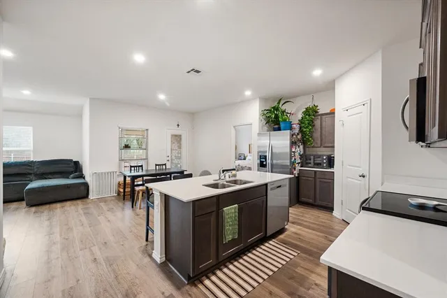 a kitchen with sink a stove and refrigerator