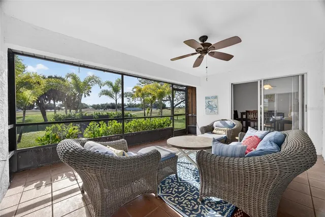 a living room with furniture and a floor to ceiling window