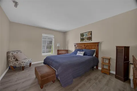a view of a back yard with a table and chair and potted plants