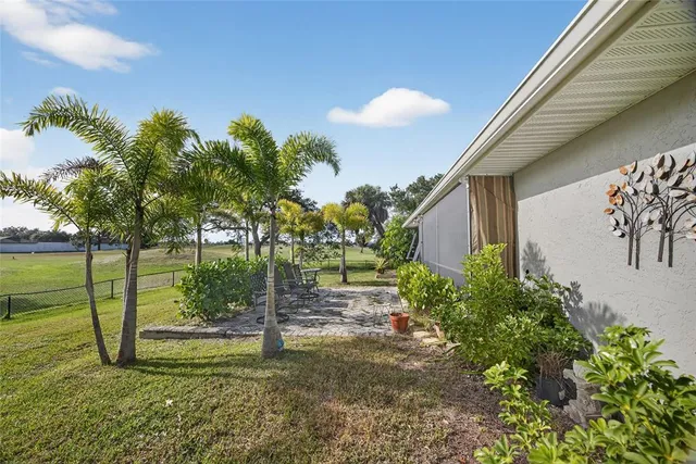 an aerial view of a house with garden space and swimming pool